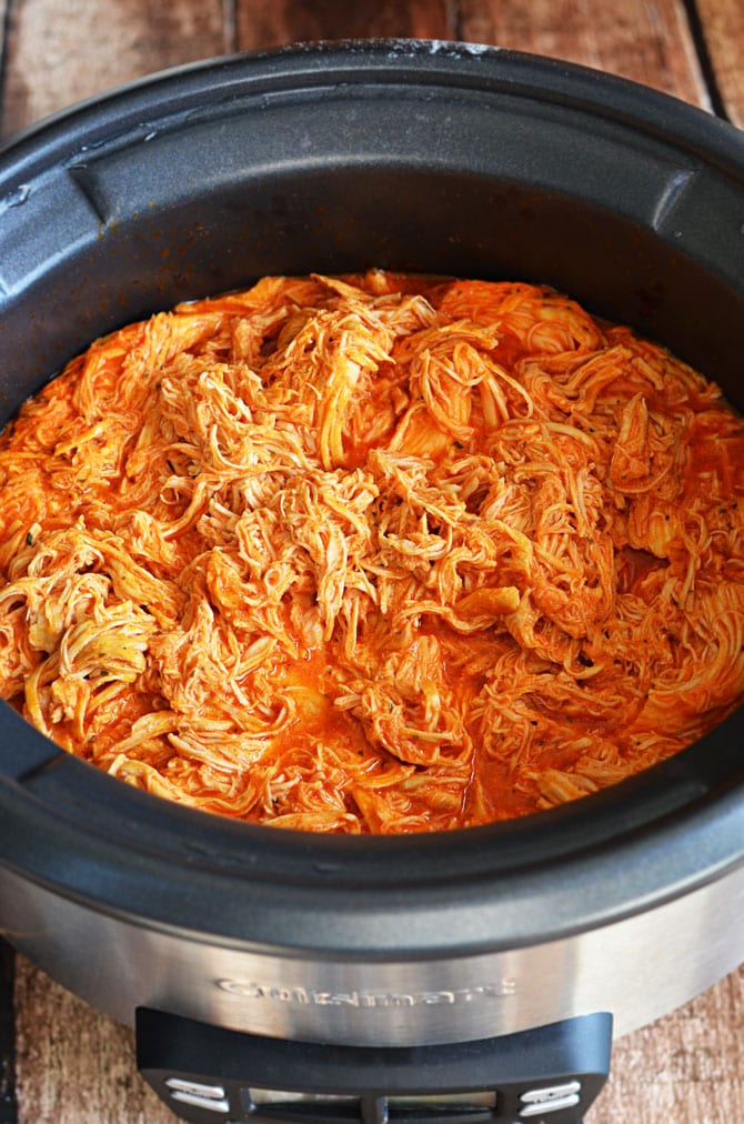 Simple Slow Cooker Shredded Buffalo Chicken. This recipe is a must-have for the Super Bowl and is so easy to make! Only 4 ingredients necessary, and it's way healthier than fried wings (although it tastes just as delicious!)! | hostthetoast.com