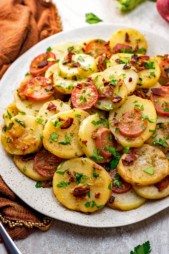German Potato Salad is the ultimate mayo-free summer side dish. With bacon, broth, and vinegar in the mix, there's no shortage of flavor in this potato salad, which is served warm or at room temperature. | hostthetoast.com