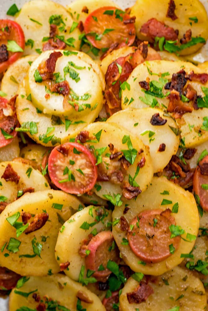 German Potato Salad is the ultimate mayo-free summer side dish. With bacon, broth, and vinegar in the mix, there's no shortage of flavor in this potato salad, which is served warm or at room temperature. | hostthetoast.com