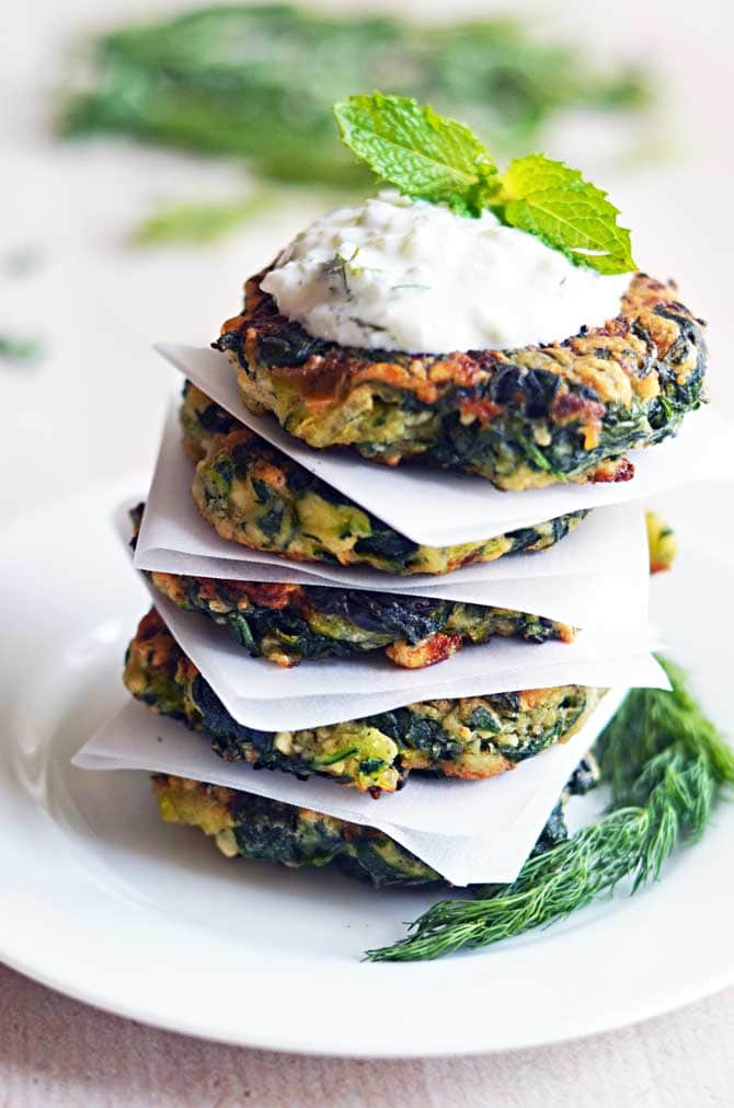 Zucchini, Feta, and Spinach Fritters with Garlic Tzatziki! Great for appetizers or a light snack, and a fantastic way to sneak in some veggies! | hostthetoast.com