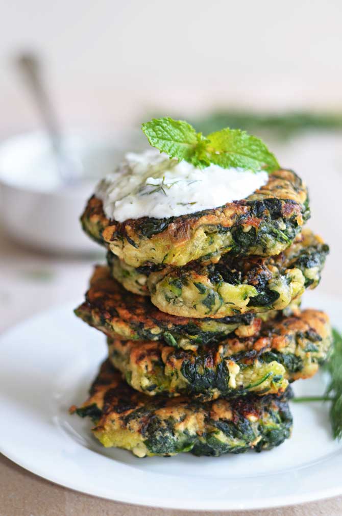 Zucchini, Feta, and Spinach Fritters with Garlic Tzatziki! Great for appetizers or a light snack, and a fantastic way to sneak in some veggies! | hostthetoast.com