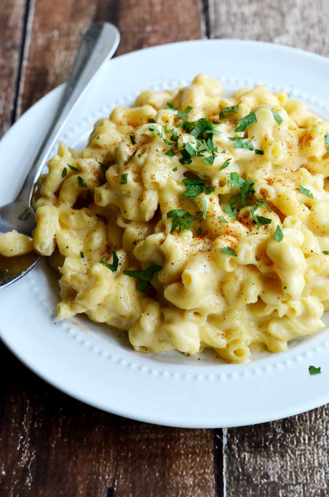 Three Cheese Crock Pot Macaroni and Cheese. So rich, so creamy, and so extremely cheesy! Just throw the ingredients in the slow cooker (even the uncooked pasta) and in just a few hours you have some of the tastiest mac out there! | hostthetoast.com