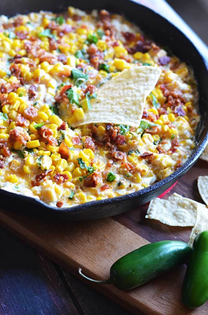 Cheesy Bacon Jalapeno Corn Dip. The sprinkle of basil seems weird but it's so amazing. This is a new football sunday must-have. Game day appetizer at its finest! | hostthetoast.com