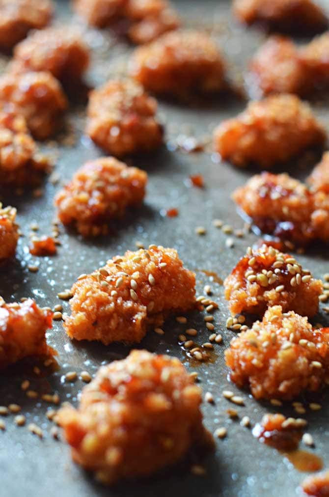 Baked Sweet Chili Garlic Popcorn Chicken.  I could eat these all day.  Great for Game Day and you won't even miss the fried wings! | hostthetoast.com