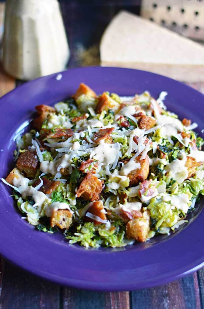 Warm Brussels Sprouts and Kale Bacon Caesar Salad.  The sprouts and kale are sauteed in the bacon drippings and then tossed with creamy Caesar dressing, homemade croutons, and plenty of freshly grated parmesan cheese.  I want to eat this every day. | hostthetoast.com