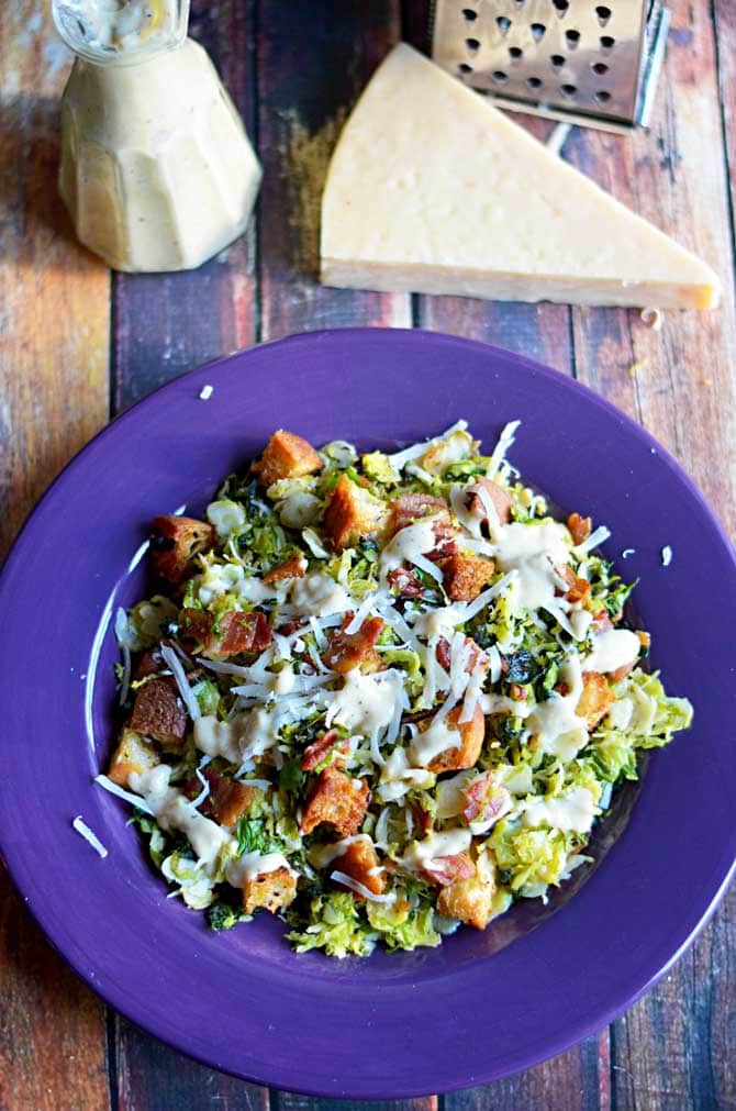 Warm Brussels Sprouts and Kale Bacon Caesar Salad.  The sprouts and kale are sauteed in the bacon drippings and then tossed with creamy Caesar dressing, homemade croutons, and plenty of freshly grated parmesan cheese.  I want to eat this every day. | hostthetoast.com