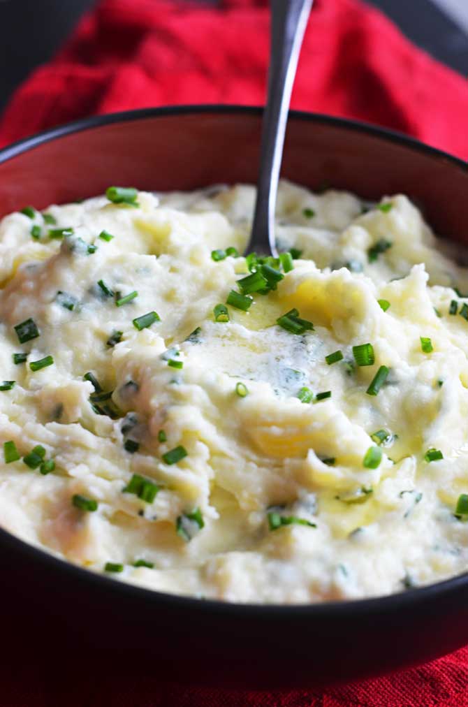 Goat Cheese and Chive Mashed Potatoes. One of the most amazing side dishes ever, and so simple to make. You've got to try them-- they'll be a hit for dinner or your Thanksgiving feast! | hostthetoast.com