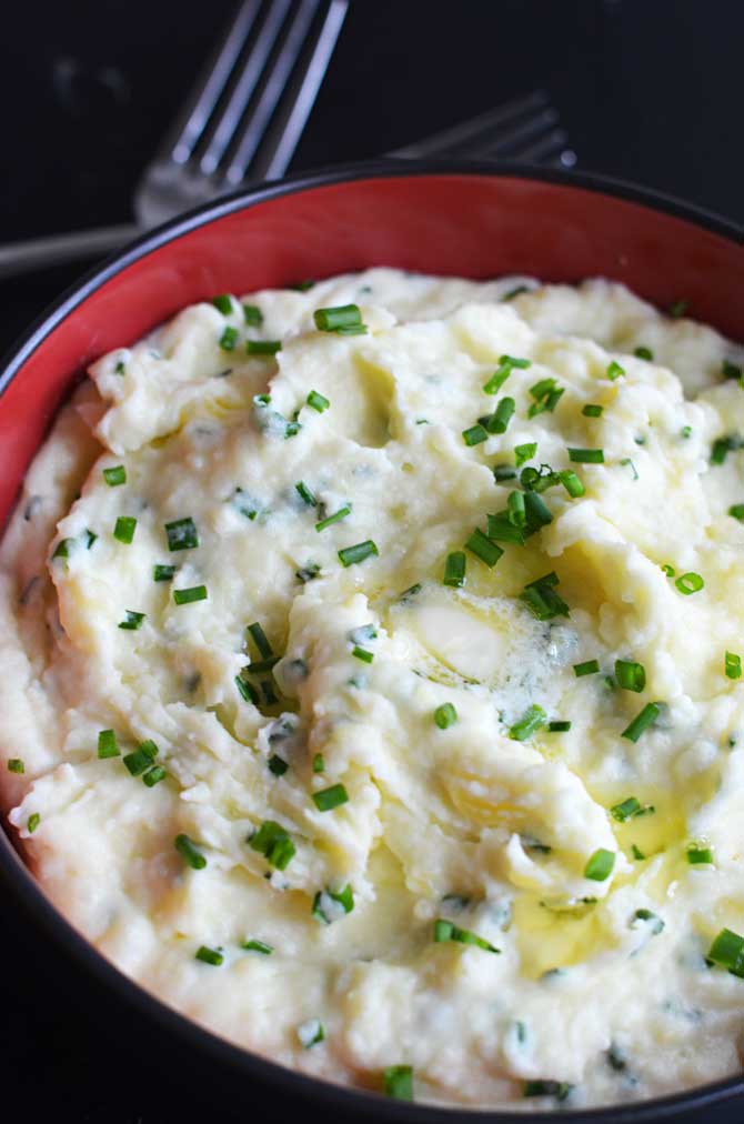 Goat Cheese and Chive Mashed Potatoes. One of the most amazing side dishes ever, and so simple to make. You've got to try them-- they'll be a hit for dinner or your Thanksgiving feast! | hostthetoast.com