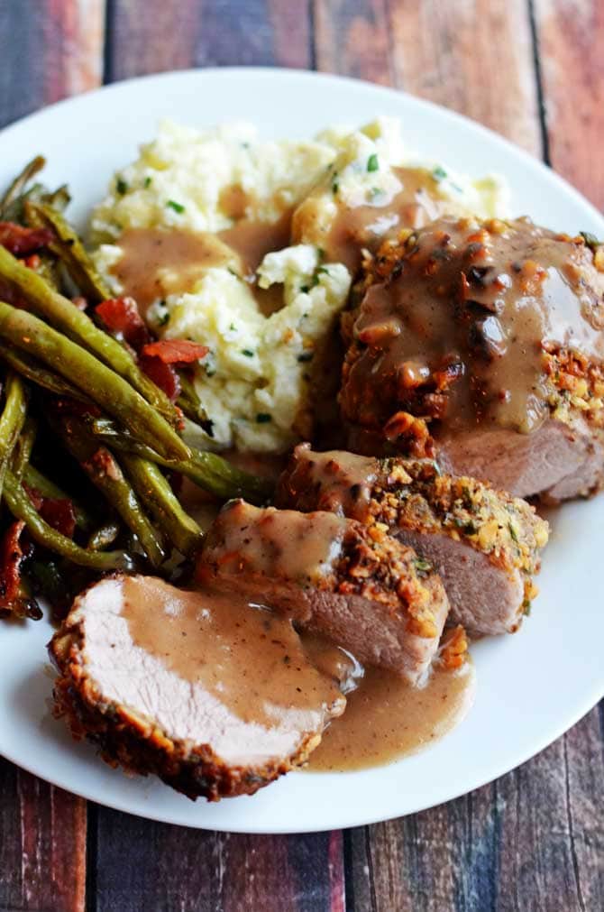 Walnut-Crusted Pork Tenderloin with Apple Cider Gravy.  Succulent, delicious, impressive, and surprisingly easier than you'd think.  Serve it with the Goat Cheese Chive Mashed Potatoes! | hostthetoast.com