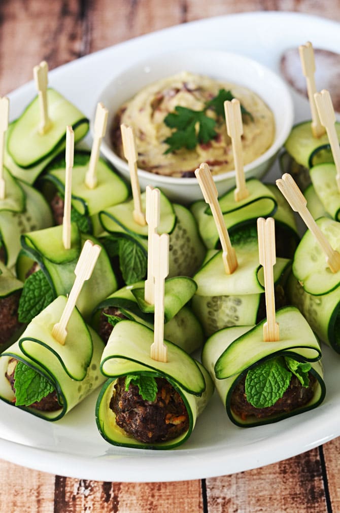 Cucumber Wrapped, Feta Stuffed Meatballs.  These Mediterranean-inspired meatballs are a HIT as an appetizer, and they're healthier than the usual options!  Served with hummus or tzatziki, they are perfect for parties!  | hostthetoast.com