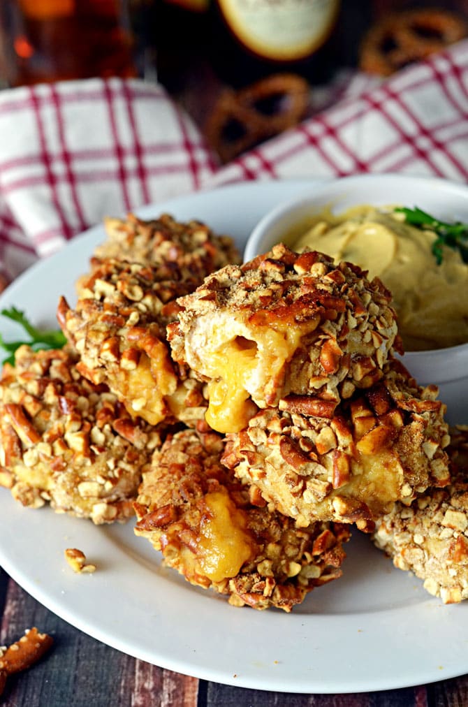 Pretzel-Crusted Chicken Nuggets Stuffed with Beer Cheese. These make the perfect Super Bowl appetizer or party treat. Grown-up chicken nuggets that make your taste buds smile. | hostthetoast.com