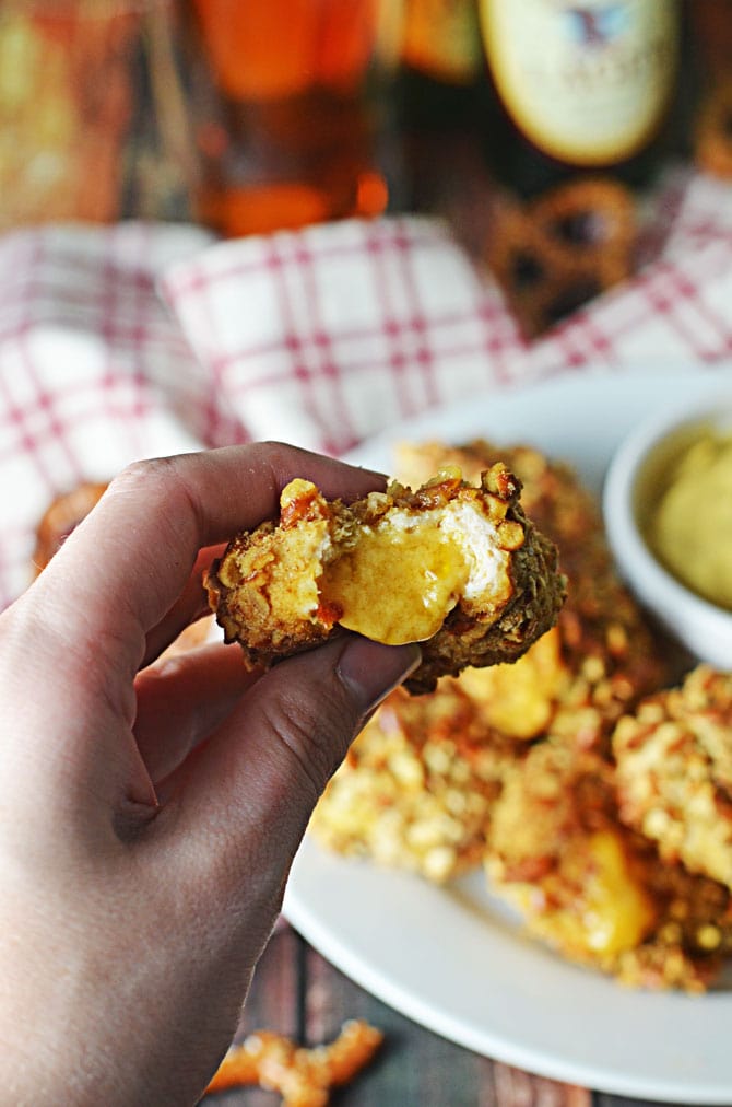 Pretzel-Crusted Chicken Nuggets Stuffed with Beer Cheese. These make the perfect Super Bowl appetizer or party treat. Grown-up chicken nuggets that make your taste buds smile. | hostthetoast.com