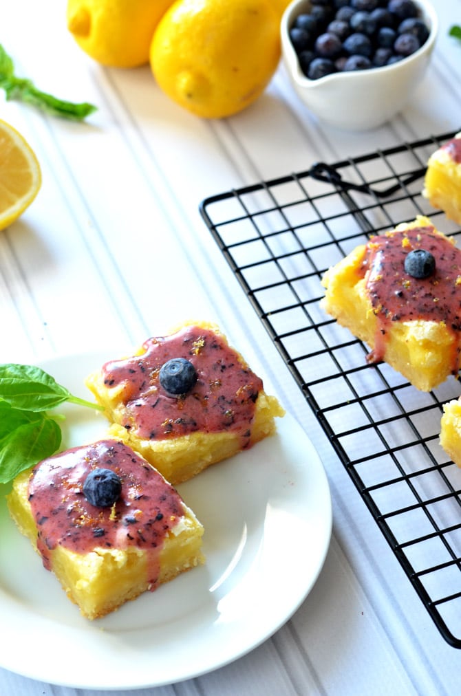 Gooey Lemon Bars with Blueberry Glaze. Tangy, sweet, rich, gooey, and out of this world. | hostthetoast.com