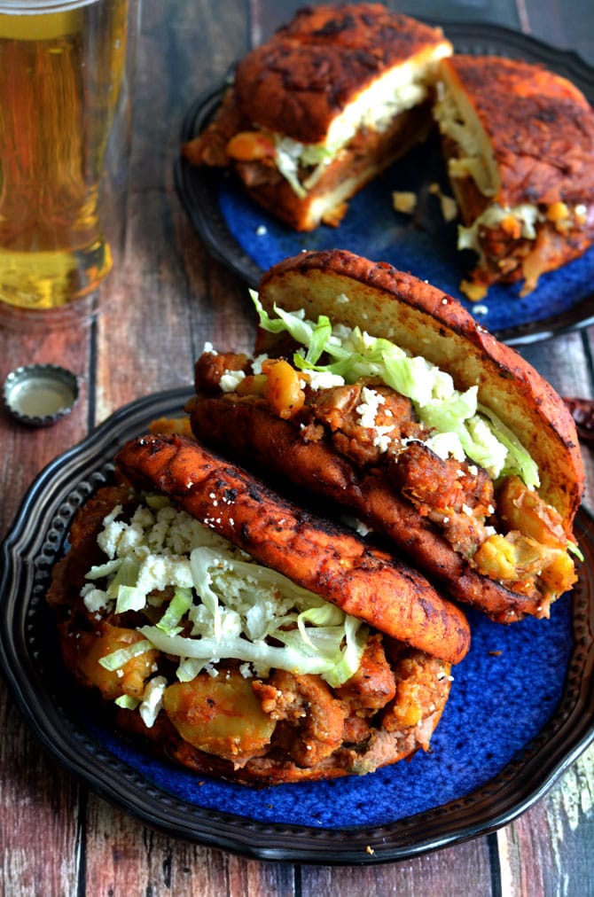 Pambazos (Mexican Salsa-Dunked Sandwiches). They're filled with potatoes, chorizo sausage, and refried beans! | hostthetoast.com