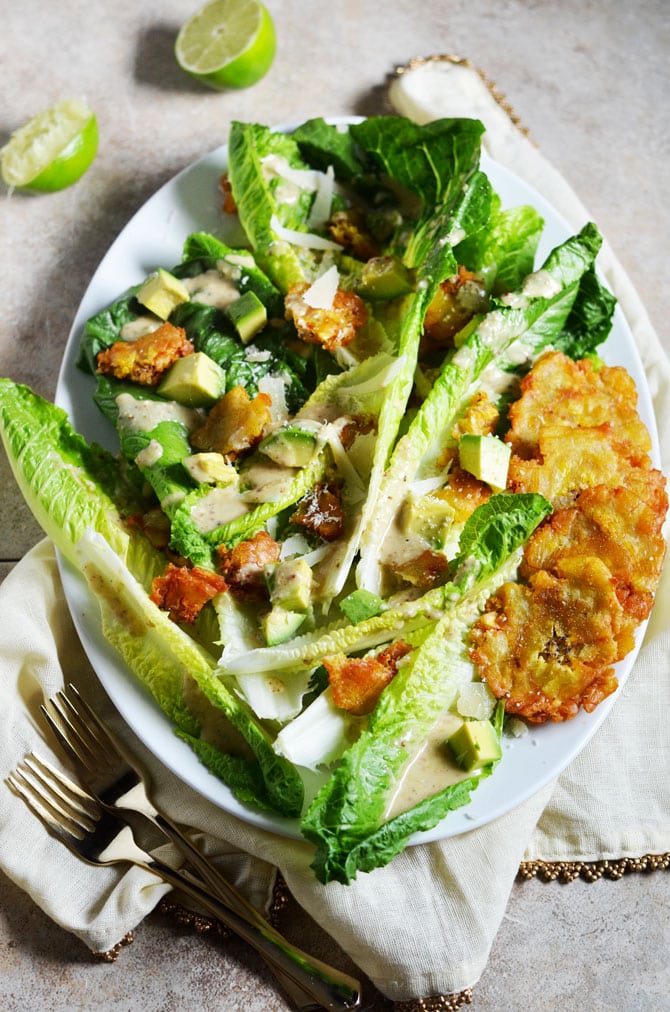 Cuban Caesar Salad. This twist on the classic Caesar features tostones, avocado, manchego cheese, and a zesty dressing that I can't get enough of. | hostthetoast.com