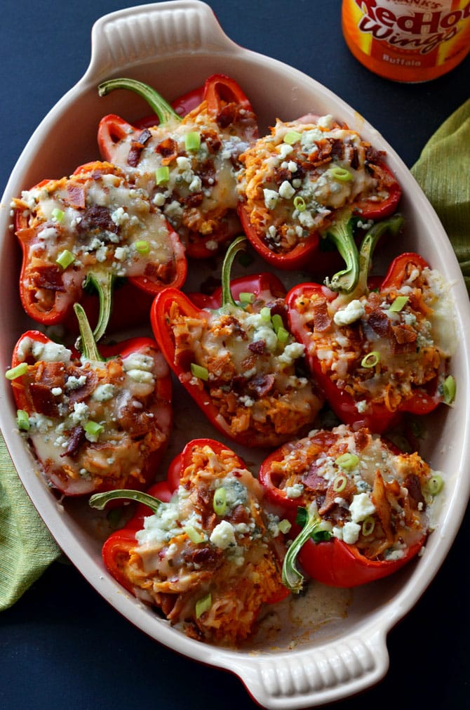 Buffalo Chicken Stuffed Peppers! These spicy stuffed peppers are loaded with monterrey jack and blue cheeses, bacon, tender shredded chicken breasts, and plenty of buffalo sauce! | hostthetoast.com