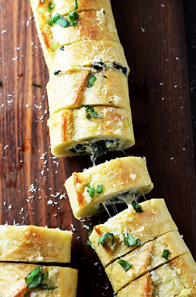 Spinach and Artichoke Dip Stuffed Garlic Bread. This is everything you've ever wanted in an appetizer and more. | hostthetoast.com