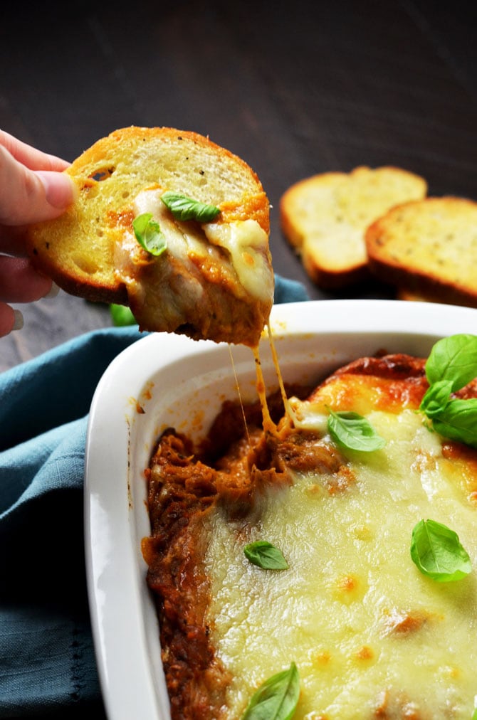Eggplant Parmesan Dip. This warm, cheesy dip is loaded up with tomato sauce, garlic, and roasted eggplant. I love making it for winter parties. | hostthetoast.com