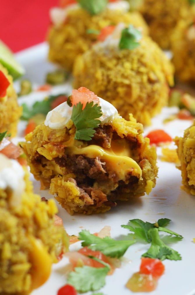 Loaded Nacho Bombs. All of the best nacho flavors in bite-sized balls. Perfect for a Super Bowl party or pot luck! | hostthetoast.com