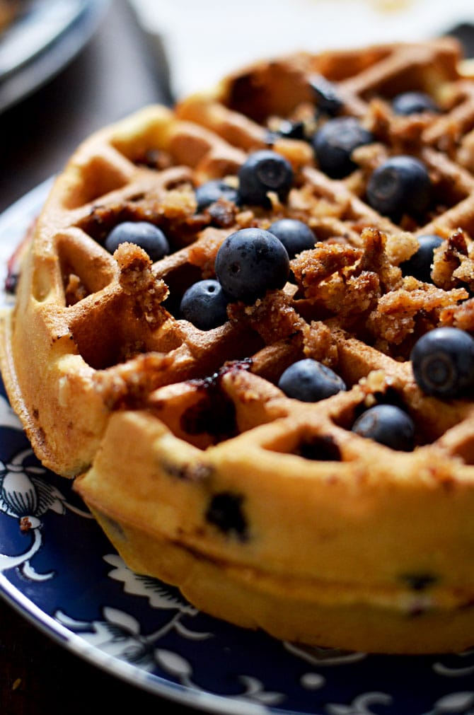 Blueberry Muffin Waffles with Cinnamon Streusel and Vanilla Glaze. These fresh blueberry loaded waffles are dense and taste just like bakery muffins but with a crisp, lightly toasted exterior. Make them a sweet treat with streusel and vanilla glaze, or simply serve them with a pat of butter. Great for a breakfast or brunch get-together. | hostthetoast.com