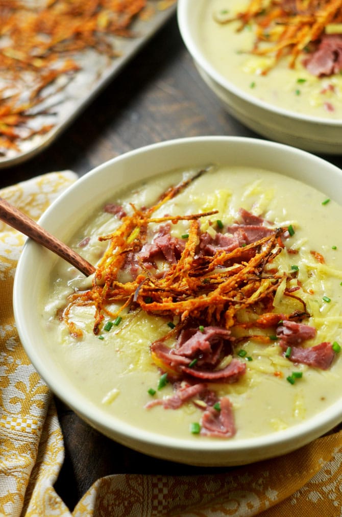 Irish Baked Potato Soup with Corned Beef and Crispy Leeks. This loaded, creamy soup tastes even better than the typical loaded baked potato soup. A great treat for St. Patrick's Day and beyond. | hostthetoast.com