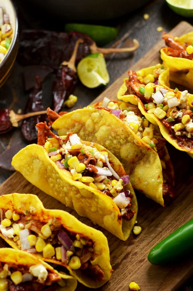 Crunchy Mexican BBQ Sauced Chicken Tacos with Charred Corn Relish. These tacos are sweet, tangy, and slightly spicy. But it's a secret ingredient in the Mexican BBQ sauce that makes them perfect. | hostthetoast.com