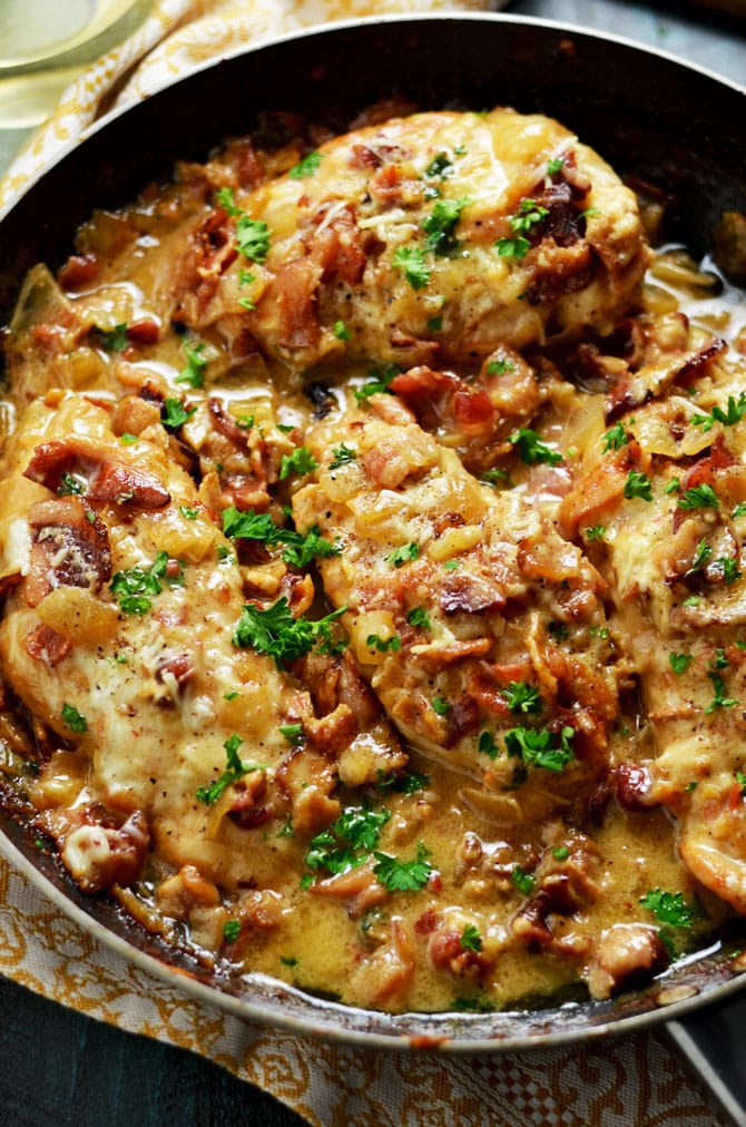 Smothered Bacon Asiago Wine Chicken. This cheesy, creamy, easy to make chicken dish is going to become a household favorite, and takes less than an hour to prepare. | hostthetoast.com
