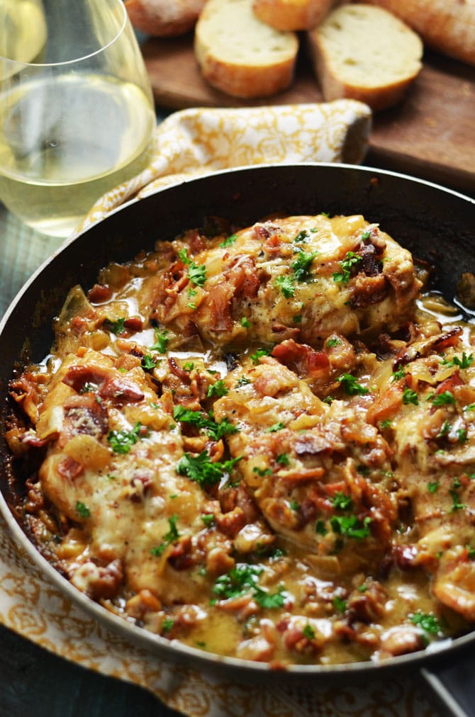 Smothered Bacon Asiago Wine Chicken. This cheesy, creamy, easy to make chicken dish is going to become a household favorite, and takes less than an hour to prepare. | hostthetoast.com