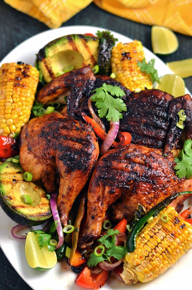 Mexican Brick Chicken with Grilled Corn and Avocados. Crispy and spicy on the outside, moist and juicy on the inside-- this grilled chicken recipe is by far the best out there. | hostthetoast.com