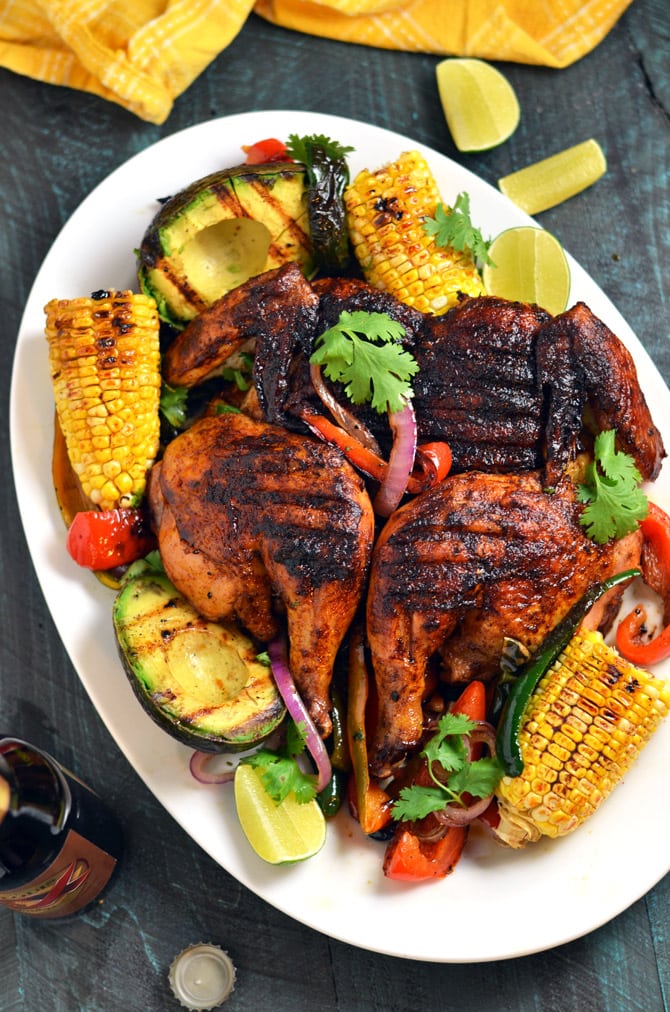 Mexican Brick Chicken with Grilled Corn and Avocados. Crispy and spicy on the outside, moist and juicy on the inside-- this grilled chicken recipe is by far the best out there. | hostthetoast.com