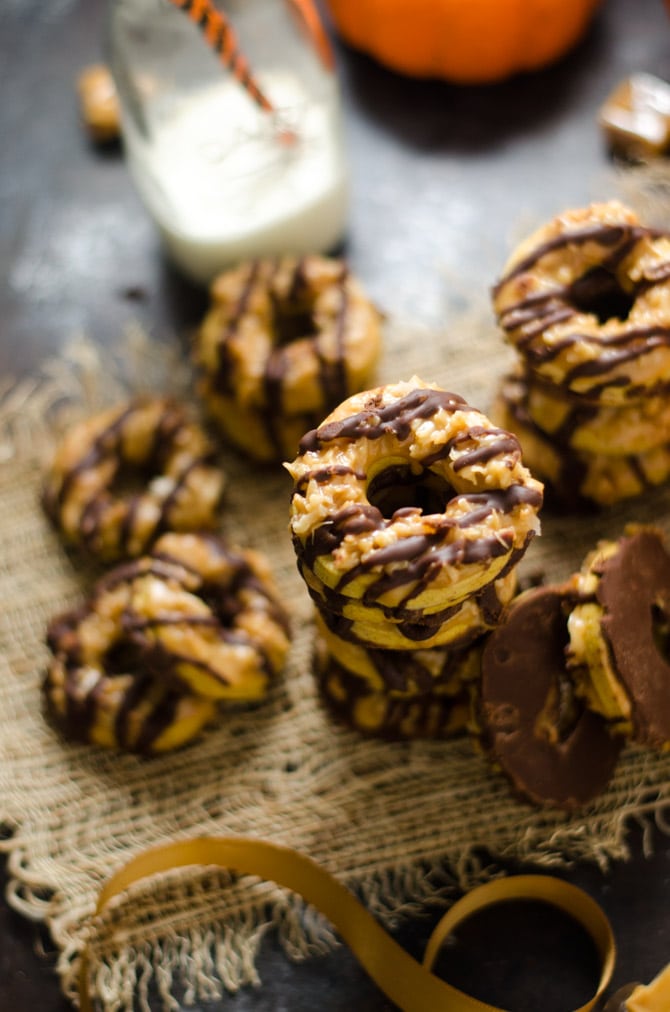 Nutella Pumpkin Samoa Cookies. The girl scout cookies you love just got better. These homemade cookies feature a pumpkin shortbread base, toasted coconut caramel topping, and nutella-chocolate drizzle. | hostthetoast.com
