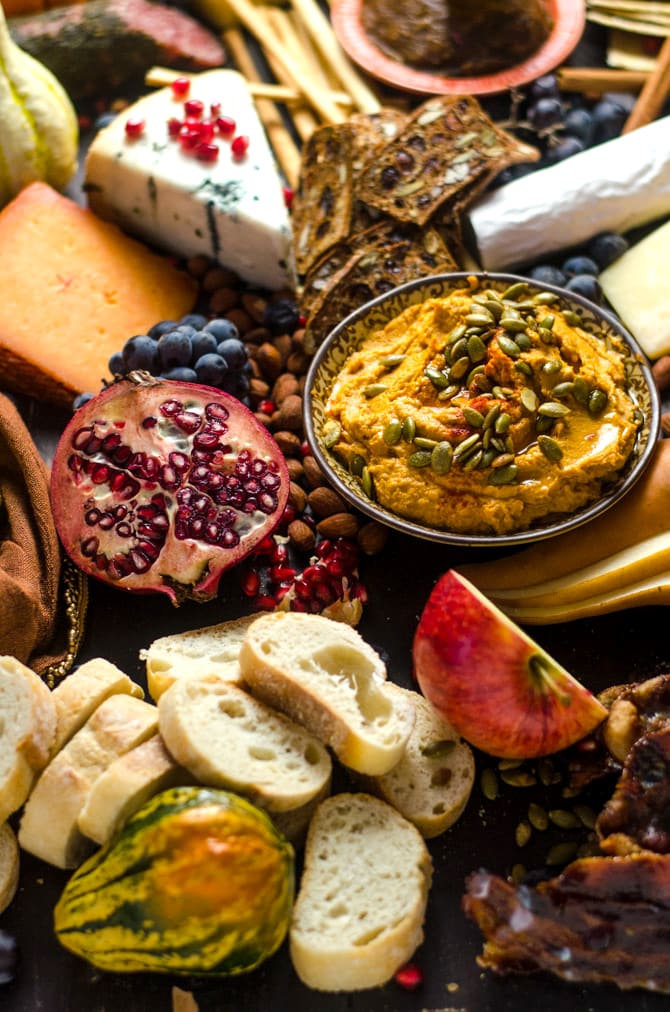 How To Make The Ultimate Autumn Harvest Cheese Board. Tips on selecting the best ingredients, plus recipes for Smoky Chipotle Pumpkin Hummus, Candied Bacon, and Bourbon Apple Butter! This is how you REALLY do Thanksgiving appetizers. | hostthetoast.com