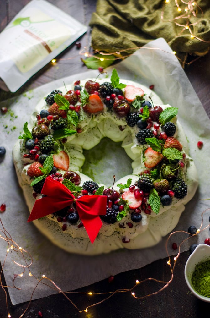 Matcha Christmas Wreath Pavlova. This sweet, smooth, and earthy-flavored dessert features a crisp crust and soft, marshmallowy center. Topped with whipped cream and berries, it is a beautiful addition to your holiday table. | hostthetoast.com