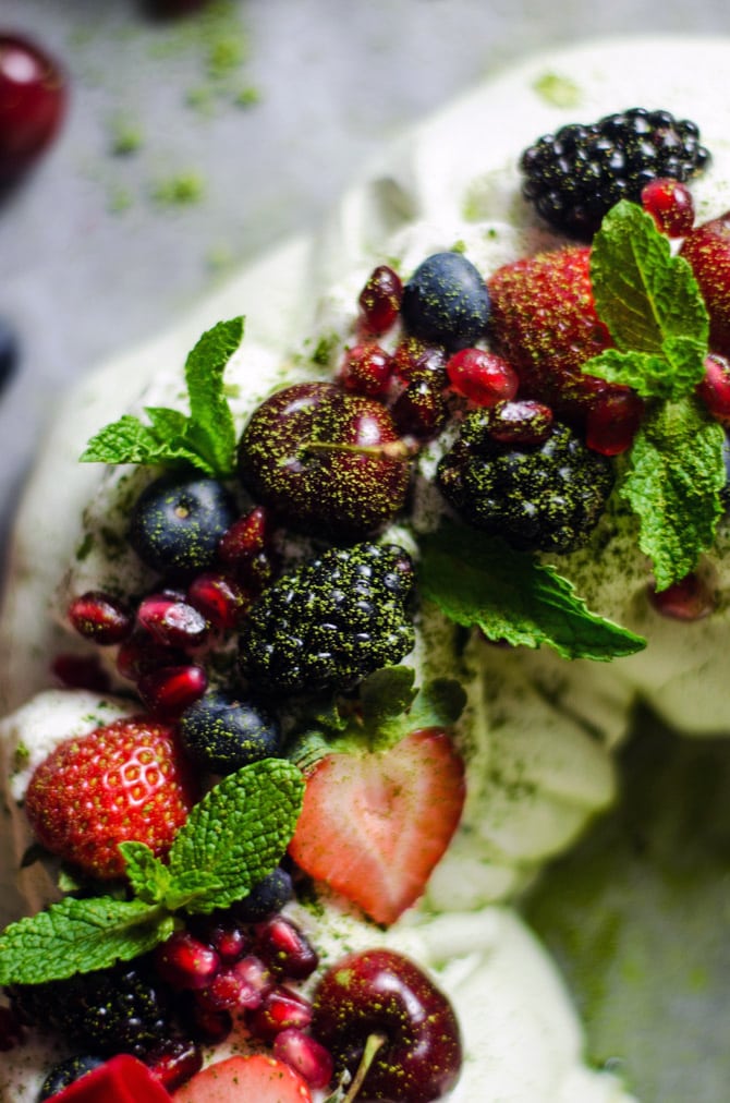 Matcha Christmas Wreath Pavlova. This sweet, smooth, and earthy-flavored dessert features a crisp crust and soft, marshmallowy center. Topped with whipped cream and berries, it makes a beautiful addition to your holiday table. | hostthetoast.com