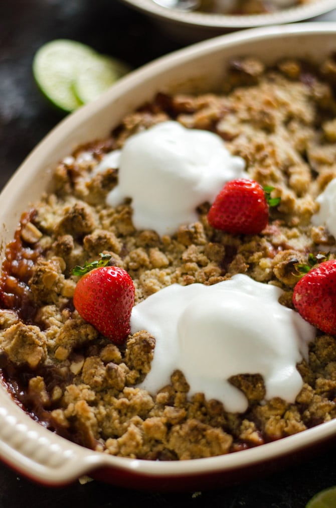 Rum-Caramelized Banana Berry Nut Crumble. This tropical-tasting dessert is incredibly easy to toss together, and is packed with flavor. It's the perfect balance of gooey filling and crisp topping! | hostthetoast.com