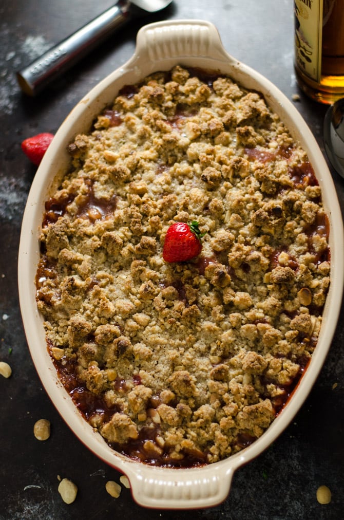 Rum-Caramelized Banana Berry Nut Crumble. This tropical-tasting dessert is incredibly easy to toss together, and is packed with flavor. It's the perfect balance of gooey filling and crisp topping! | hostthetoast.com