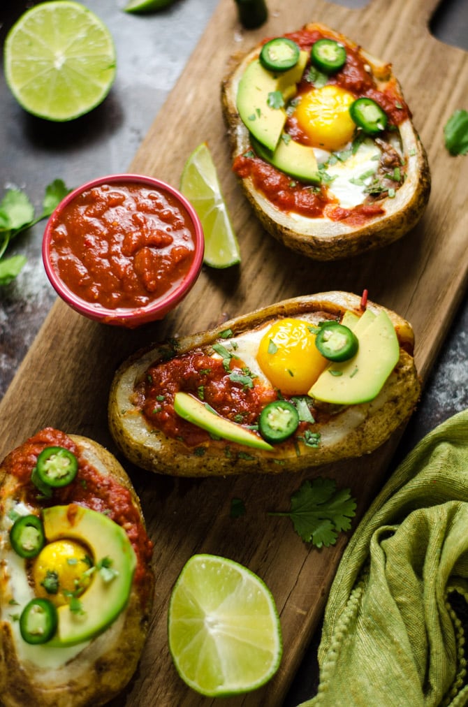 30 Minute Huevos Rancheros Potato Boats. Potato skins meet Mexican breakfast in this delicious and easy recipe featuring eggs, refried beans, cheese, salsa, avocado, and crisp potatoes. | hostthetoast.com