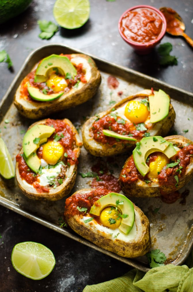 30 Minute Huevos Rancheros Potato Boats. Potato skins meet Mexican breakfast in this delicious and easy recipe featuring eggs, refried beans, cheese, salsa, avocado, and crisp potatoes. | hostthetoast.com