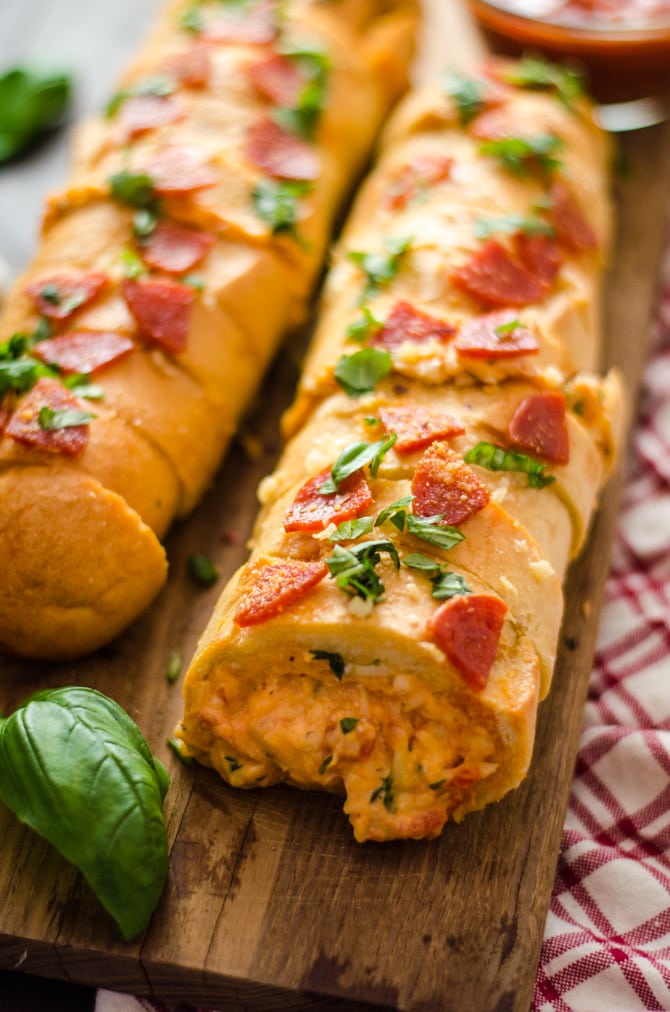 Pepperoni Pizza Stuffed Garlic Bread. A cheesy, tomato-sauce spiked dip gets packed inside of buttery bread for an easy-to-make, crowd-pleasing Super Bowl appetizer. | hostthetoast.com