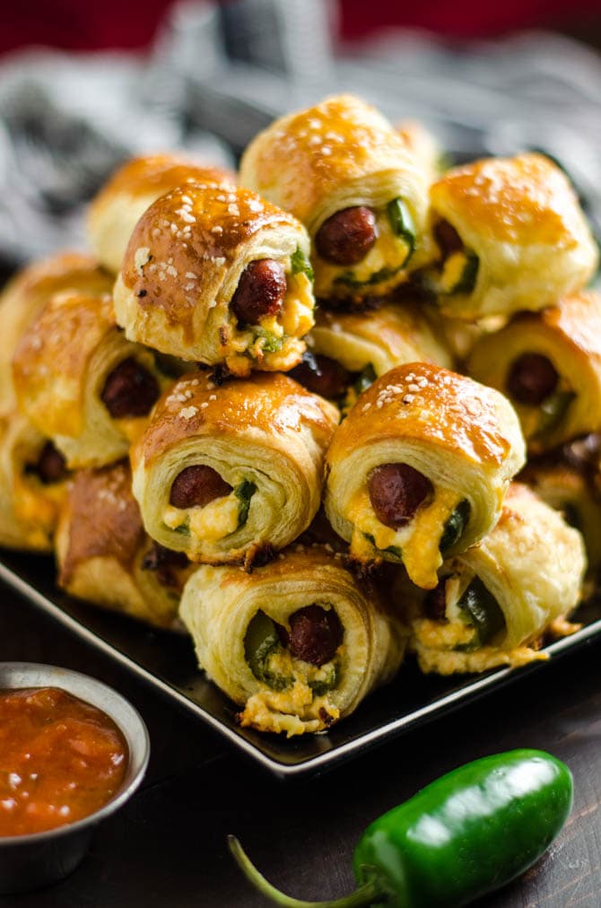 Jalapeno Popper Pigs in a Blanket. These spicy, cheesy appetizers are perfect for your next party or game day! | hostthetoast.com