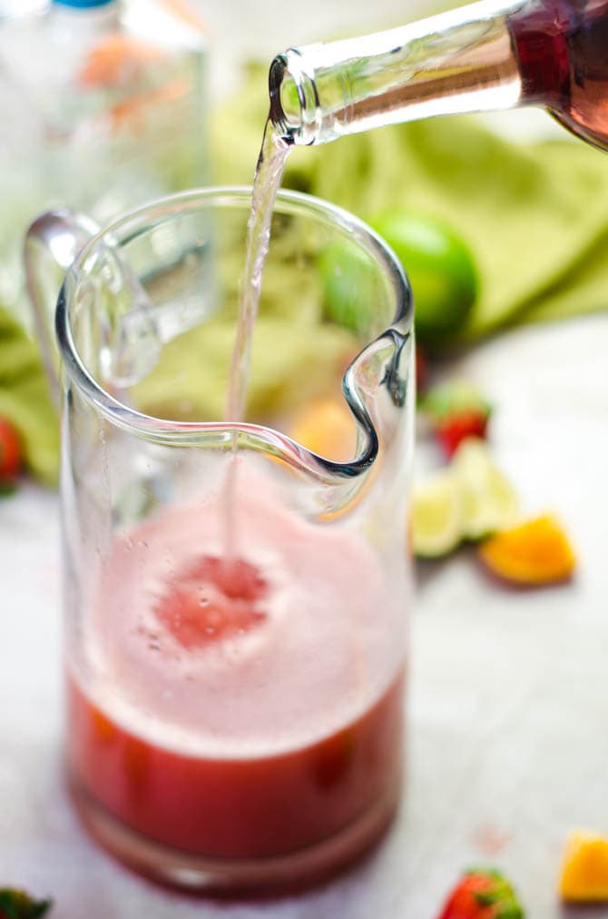 Spend this weekend sipping Strawberry Sangarita-- the love child of margaritas and sangria. This cocktail is over-the-top delicious and perfect for parties. | hostthetoast.com
