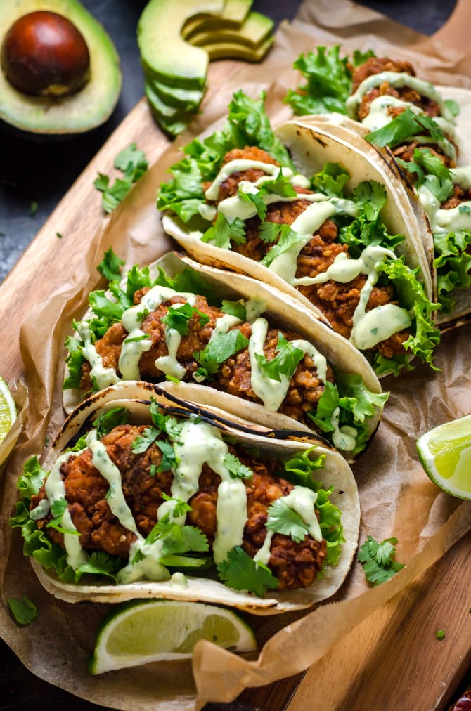 Crispy Chicken Tacos with Avocado Buttermilk Ranch. These tacos aren't traditional by any means, but they ARE delicious. Crispy, Mexican-seasoned chicken tenders + cool, creamy avocado ranch sauce are a match made in taco heaven. | hostthetoast.com