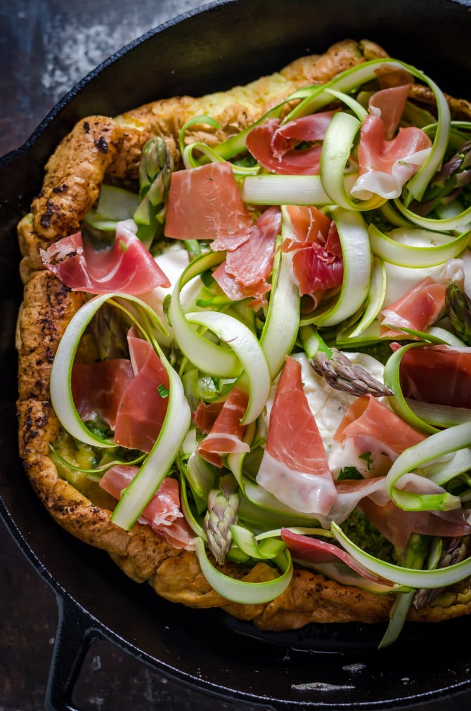 Dutch Baby Pesto Breakfast Pizza. This pancake-pizza hybrid is loaded up with herbs, prosciutto, shaved asparagus, burrata cheese, and eggs. Total brunch material. | hostthetoast.com