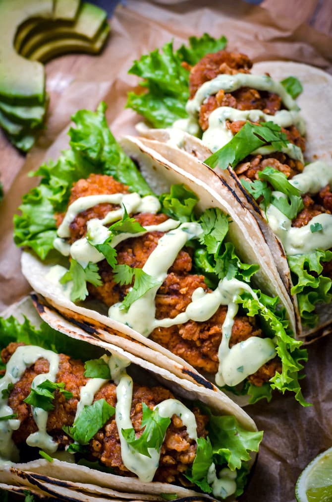 Crispy Chicken Tacos with Avocado Buttermilk Ranch. These tacos aren't traditional by any means, but they ARE delicious. Crispy, Mexican-seasoned chicken tenders + cool, creamy avocado ranch sauce are a match made in taco heaven. | hostthetoast.com