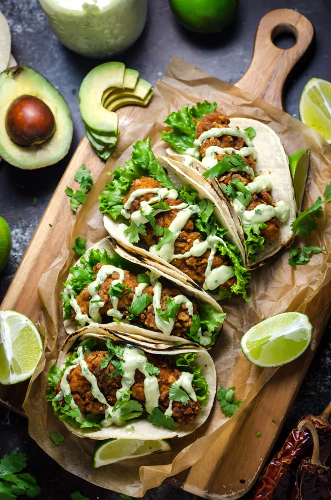 Crispy Chicken Tacos with Avocado Buttermilk Ranch. These tacos aren't traditional by any means, but they ARE delicious. Crispy, Mexican-seasoned chicken tenders + cool, creamy avocado ranch sauce are a match made in taco heaven. | hostthetoast.com