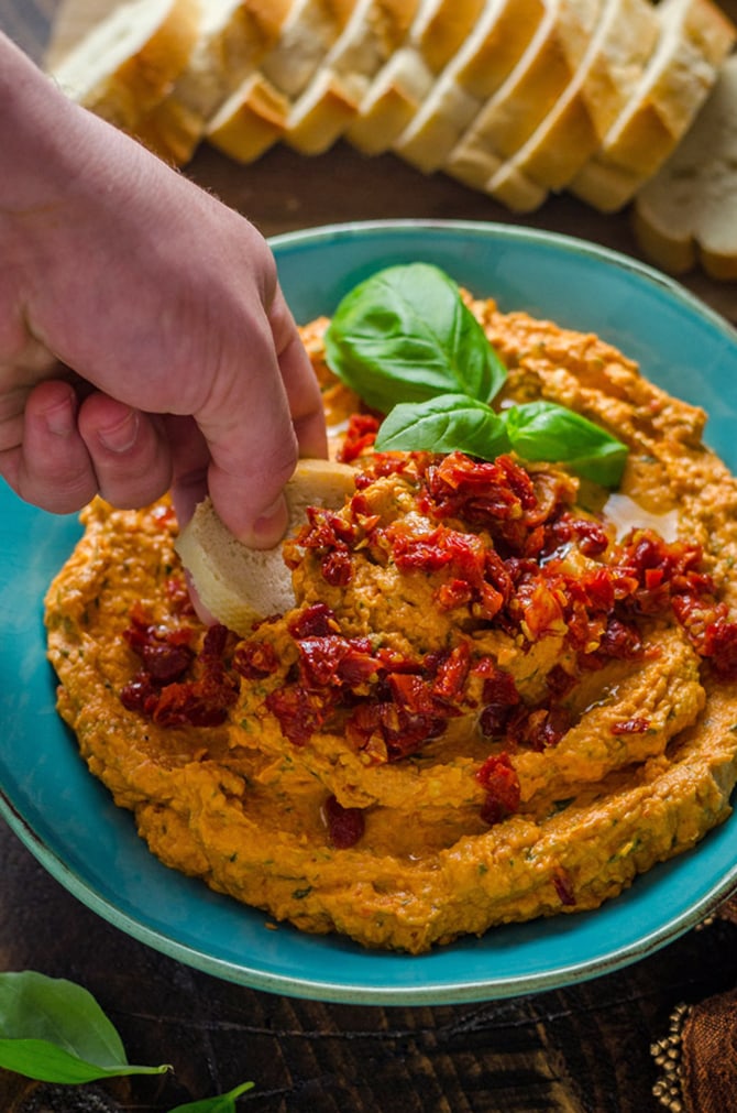Creamy Sun Dried Tomato Basil Bean Dip. This white bean dip features cream cheese, sun dried tomatoes, lemon juice, fresh basil, and garlic, and comes together in minutes! It's the perfect spread for summer. | hostthetoast.com