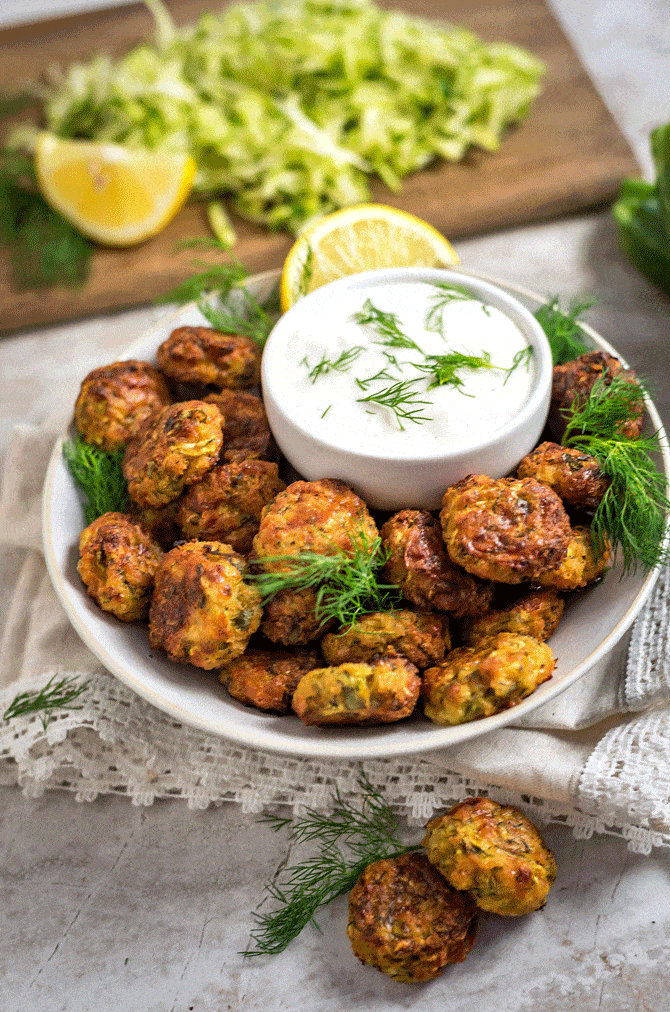 Cheesy Garlic Zucchini Bites. These are easy to make, super flavorful, and baked so they're much healthier than fritters! Serve 'em as snacks, appetizers, or even a side dish! | hostthetoast.com