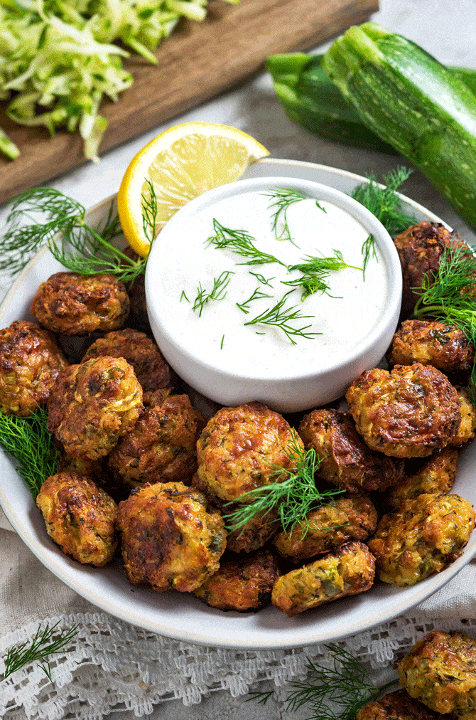 Cheesy Garlic Zucchini Bites. These are easy to make, super flavorful, and baked so they're much healthier than fritters! Serve 'em as snacks, appetizers, or even a side dish! | hostthetoast.com