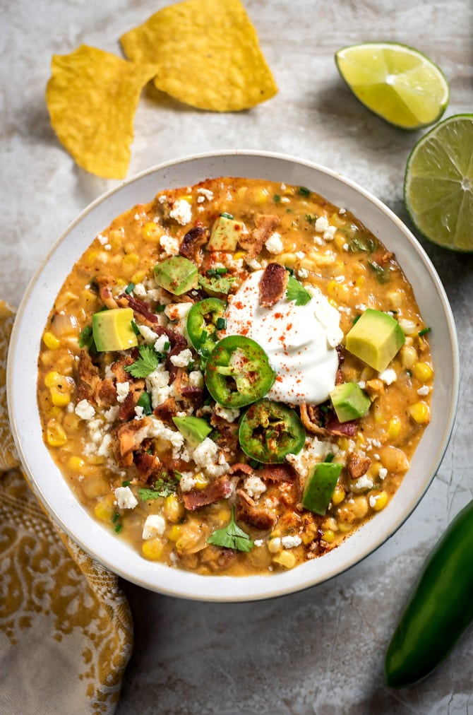 Slow Cooker Mexican Street Corn Chowder. This soup is loaded up with smoky, tangy, spicy, and salty flavors-- you're never going to want regular ol' corn chowder again. | hostthetoast.com