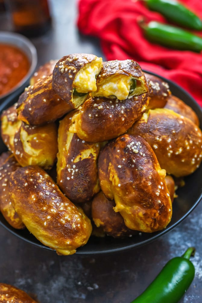 Jalapeño Popper Pretzel Bites. These cheesy, spicy party appetizers are so easy to make thanks to a premade dough shortcut! A video in the post shows exactly how it's done. | hostthetoast.com